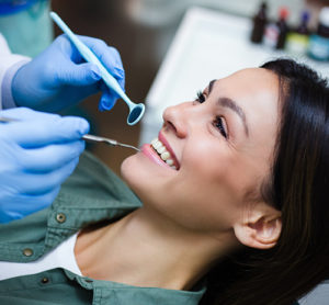 woman having teeth cleaned and consultation for teeth whitening services